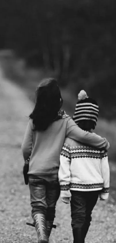 Two brothers walking arm in arm down a quiet, forest path in grayscale.