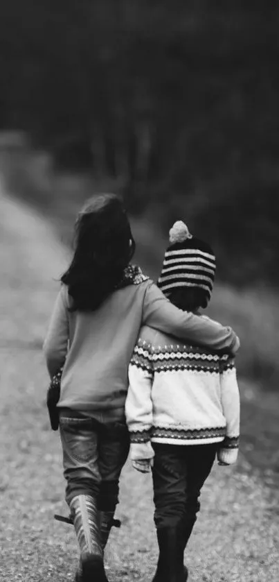 Black and white image of children walking on a wooded path.