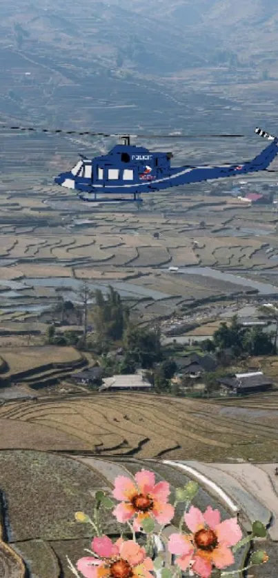 Helicopter flying over rice terraces with flowers below.