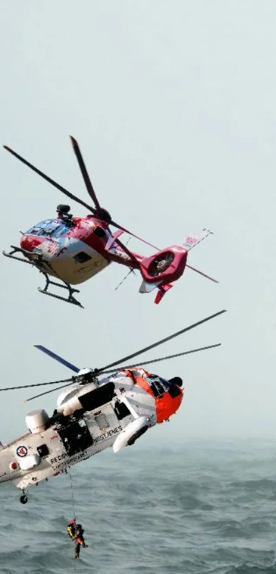 Two helicopters in an ocean rescue mission with a suspended rescuer.