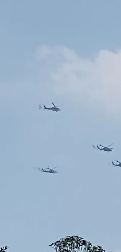 Helicopters soar in a clear blue sky.