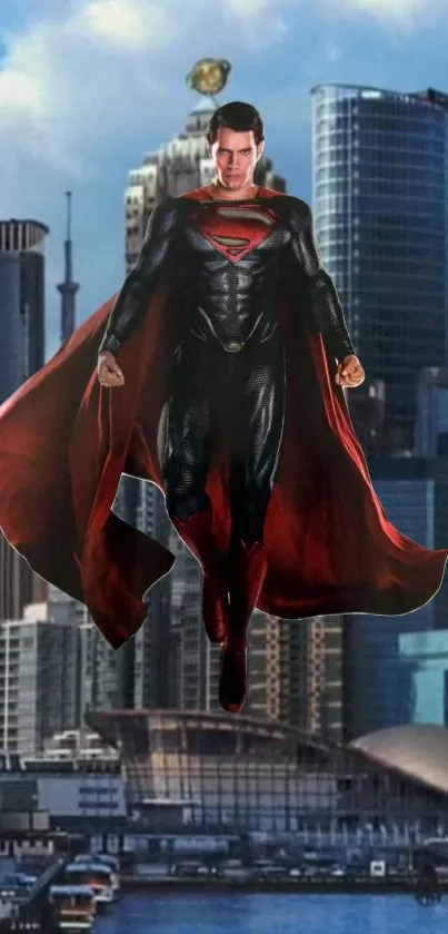 Superhero flying over city skyline with red cape.