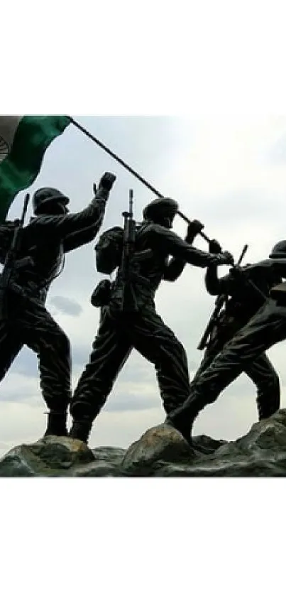 Soldiers raising a flag sculpture against sky.