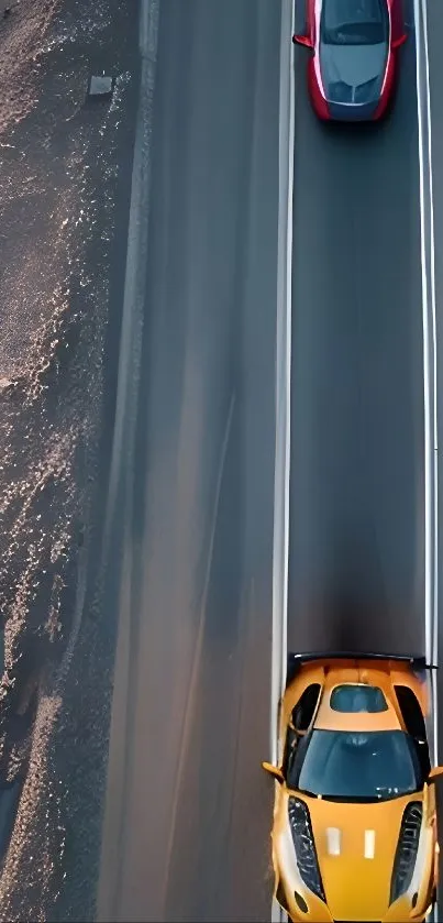 Aerial view of two fast cars driving on an open road.