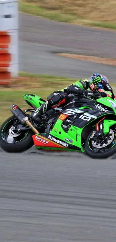 Vibrant green Kawasaki motorcycle racing on a track with a speed rider.