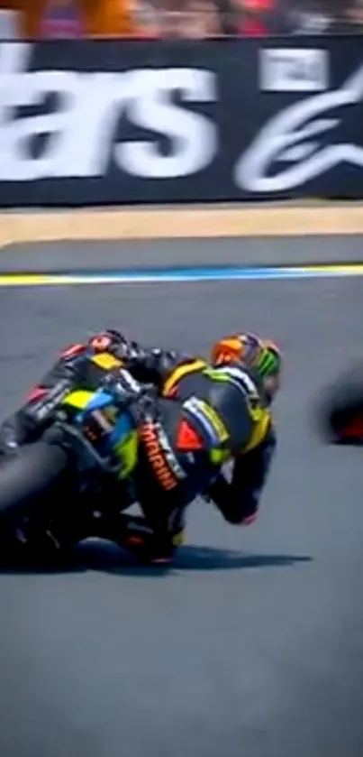 Motorcycle racer leaning into high-speed turn on track.