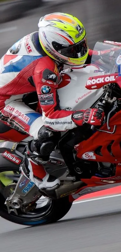 Motorcycle rider in vibrant red suit racing on track.