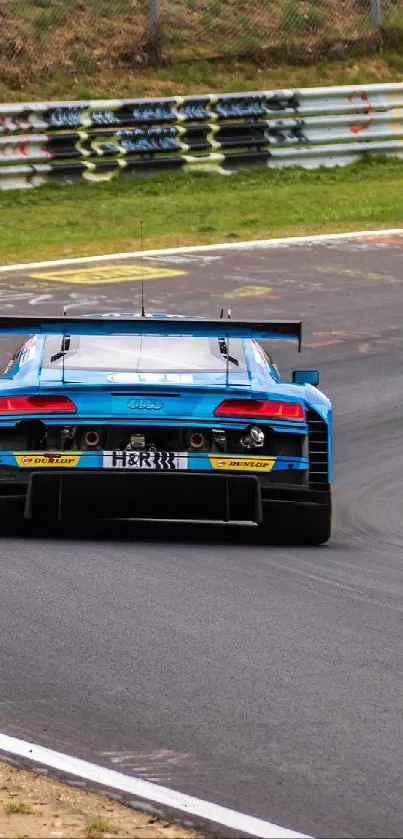 Blue sportscar racing on a track curve.