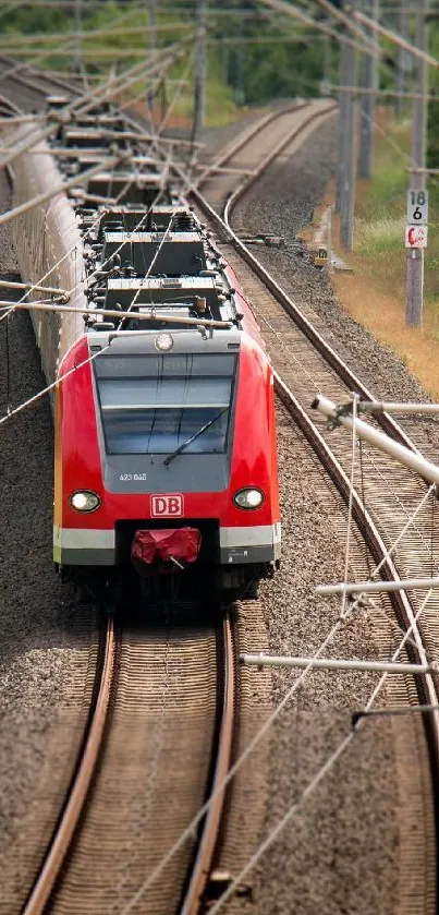 High-speed red train on railway tracks.