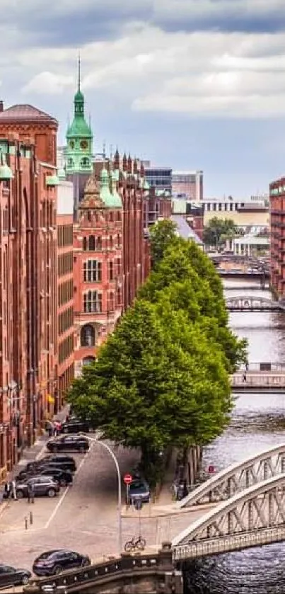 Historic brick buildings along a scenic canal with cloudy sky.