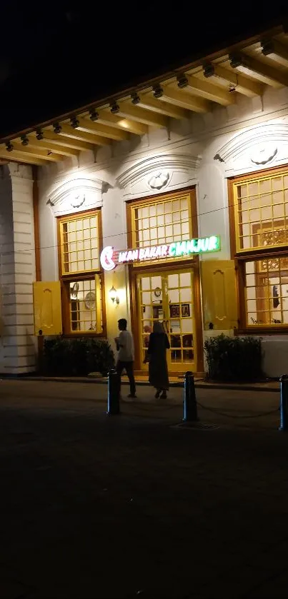 Illuminated historic building at night street.