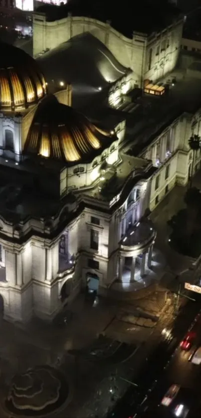 Nighttime view of a historic building facade with glowing lights.