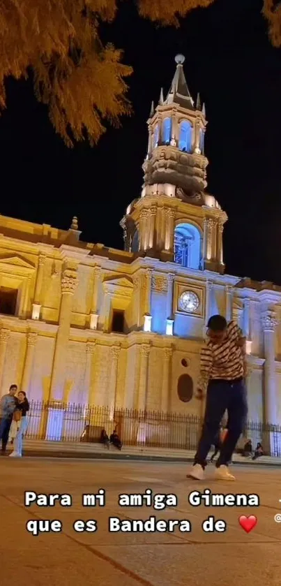 Night view of a historic building with warm lighting and architectural details.