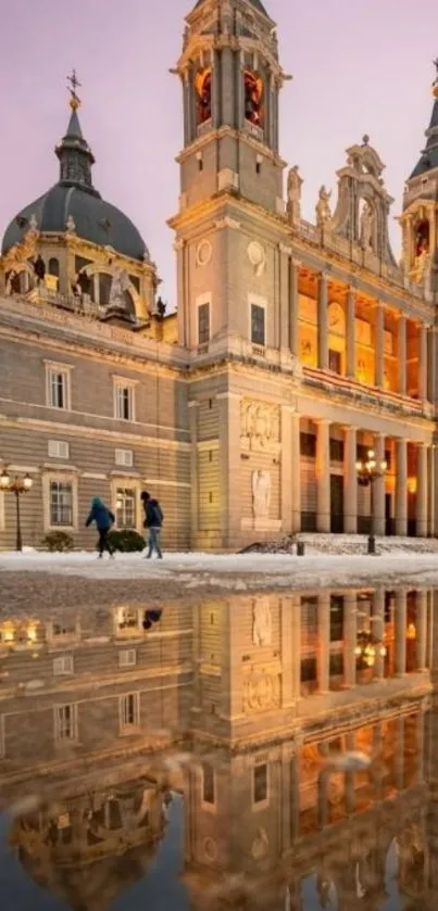 Historic cathedral reflecting in water at sunset with warm tones.