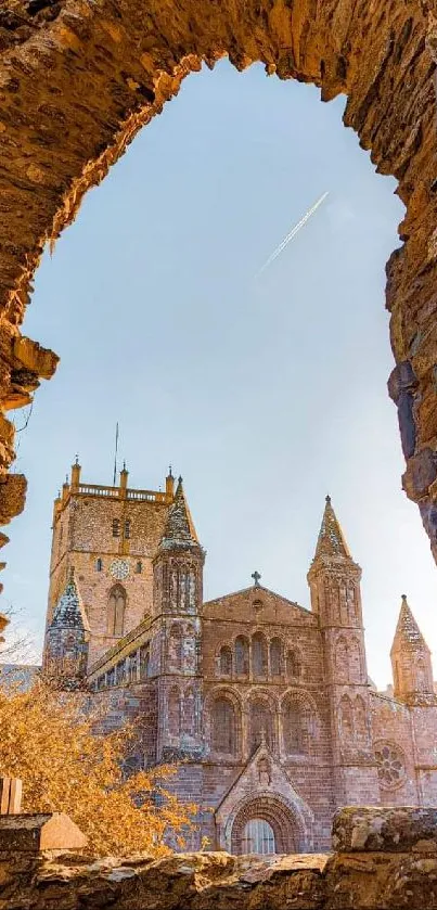 View of a historic cathedral through an ancient stone archway.