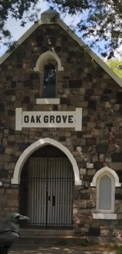 Historic stone chapel surrounded by trees and greenery.