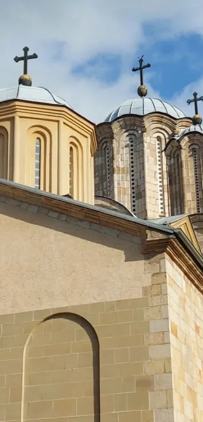 Historic stone church with domed architecture on a sunny day.