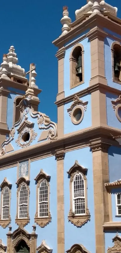 Elegant church facade against blue sky, perfect for mobile wallpaper.