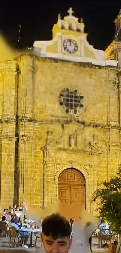 Historic church facade beautifully lit at night, perfect for a serene wallpaper.