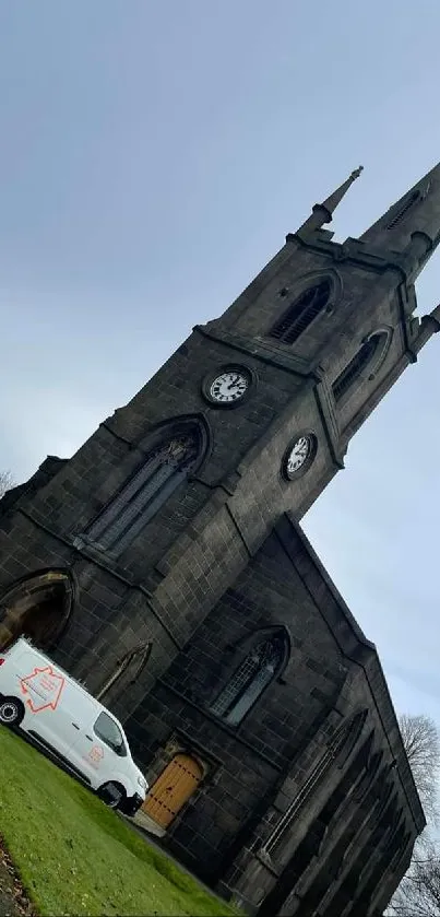 Mobile wallpaper showing a historic church tower under a cloudy sky.