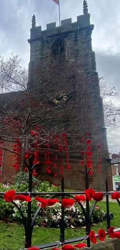 A historic church with red poppies on a grey, cloudy day.