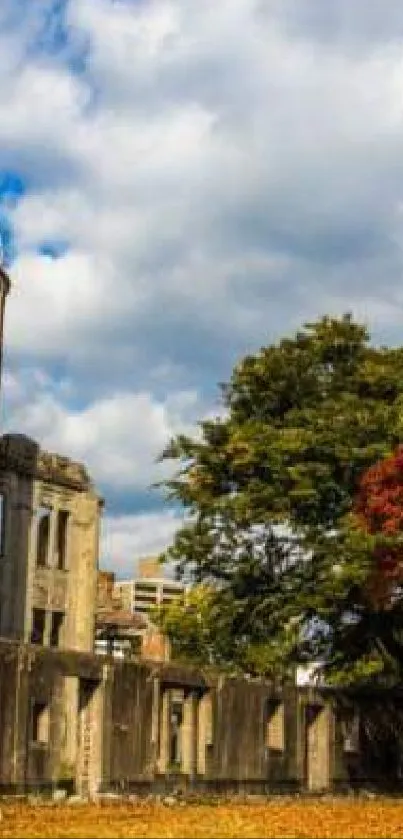 A-Bomb Dome with vibrant autumn colors and golden leaves under a cloudy sky.