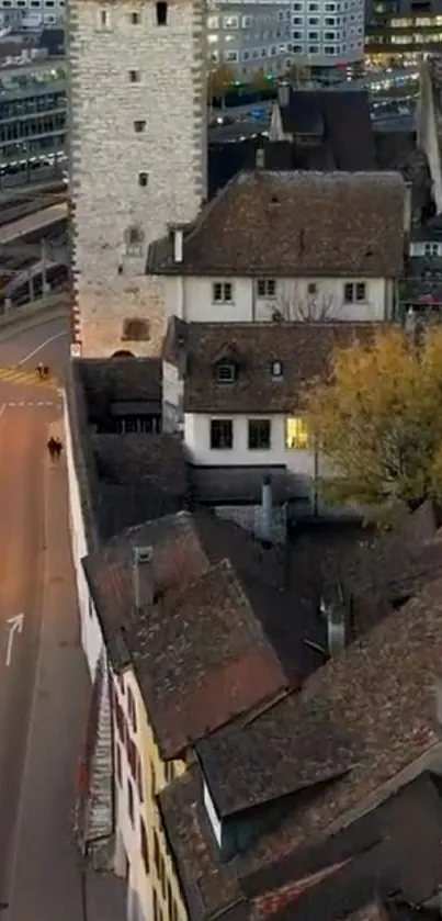 Aerial view of historic European rooftops at dusk.