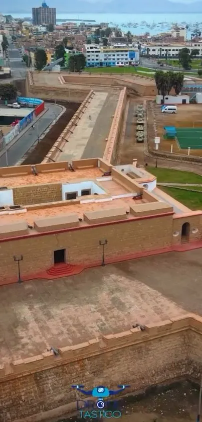 Aerial view of a historic fort in a cityscape setting.