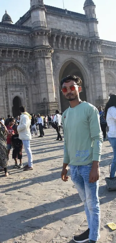 Gateway of India with crowd and tourist featuring historic architecture.