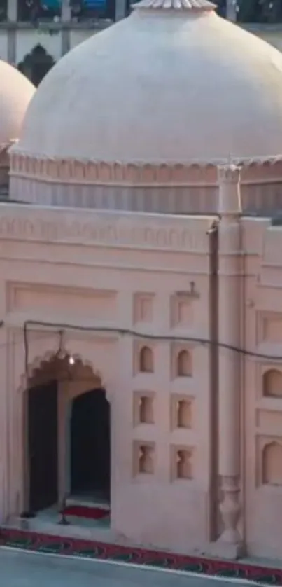 Beige dome mosque architecture with intricate design.