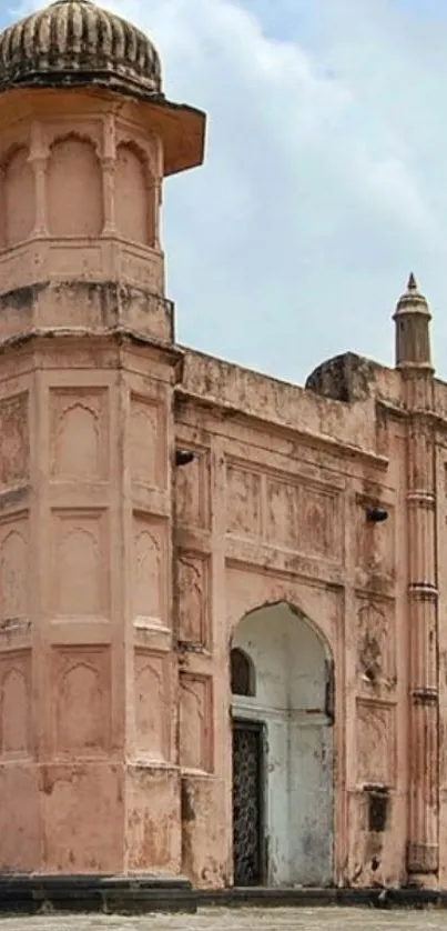 Historic pink building with sky in background.