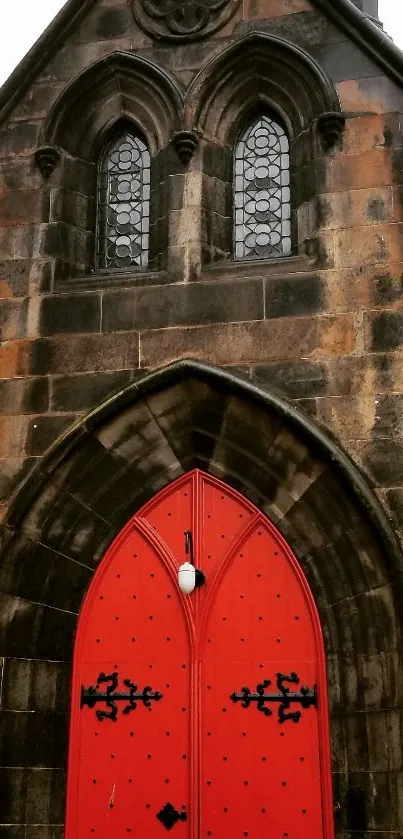 Red door set in a stone archway with Gothic design and vintage charm.