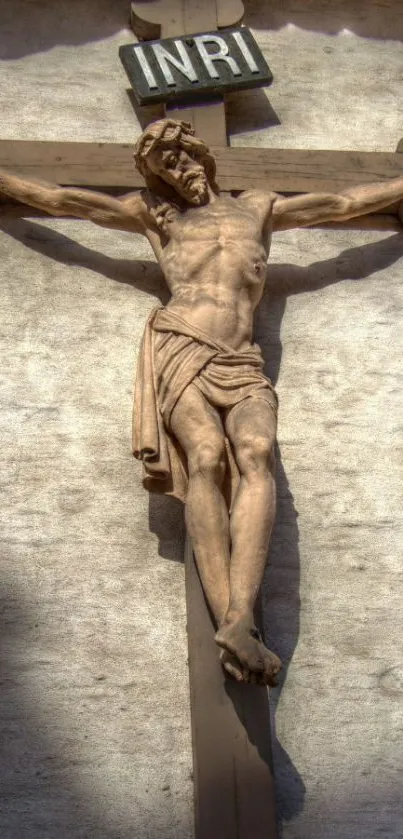 Historic crucifix sculpture on beige wall.