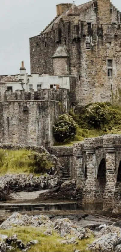 Historic Scottish castle surrounded by lush green landscape and stone architecture.