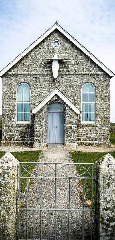 Historic stone chapel in rural landscape wallpaper.