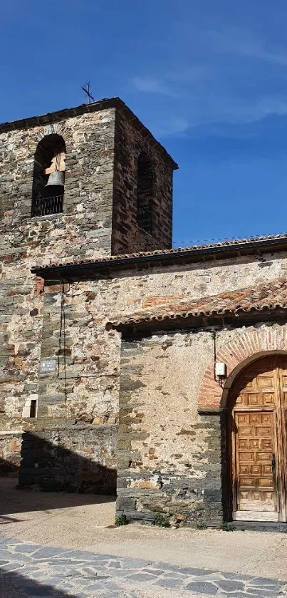 Historic stone church under a blue sky.