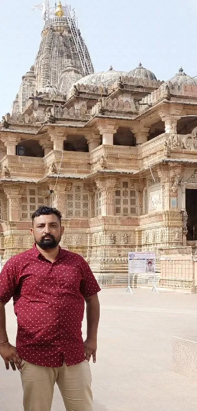 Ancient temple with a visitor standing in front on a sunny day.