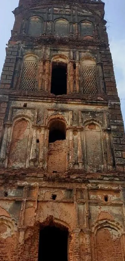 Ancient brick tower against a blue sky, showcasing historic architecture.