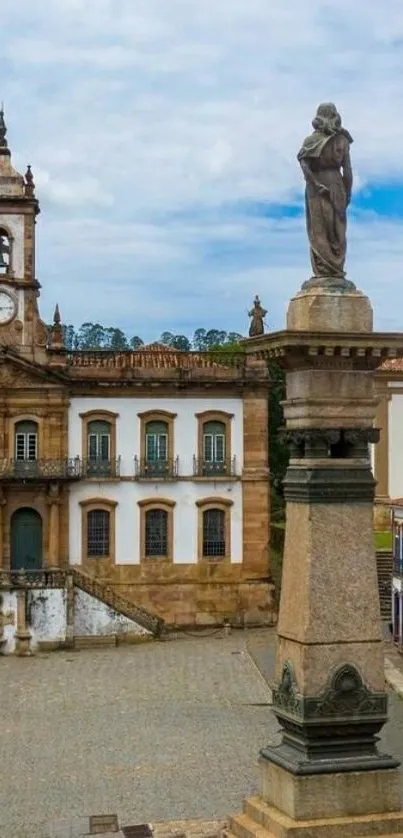 Historic town square with statue and clock tower.