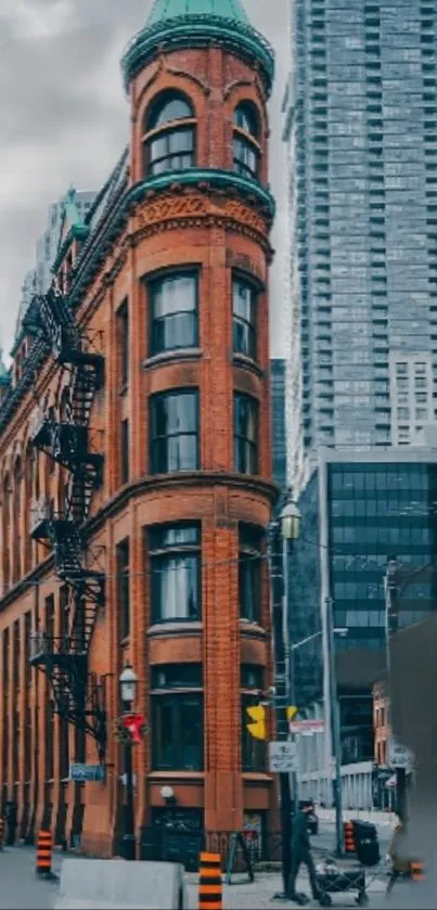 Red-brick building amid a modern cityscape, showcasing historic urban architecture.