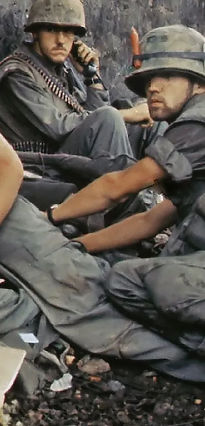 Vietnam War soldiers resting in jungle clearing.