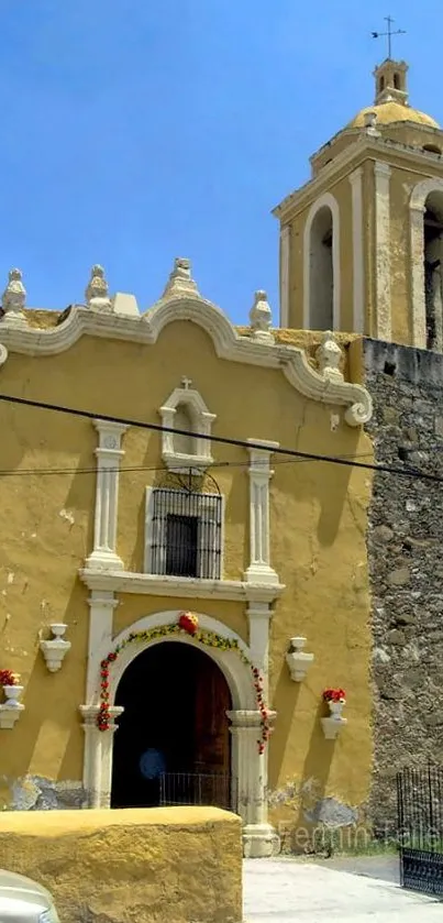 Historic yellow church with stone tower.