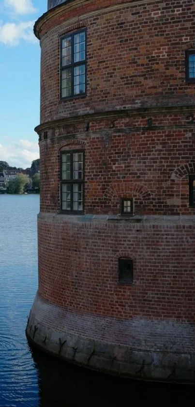 Historic brick tower by a serene lakeside.