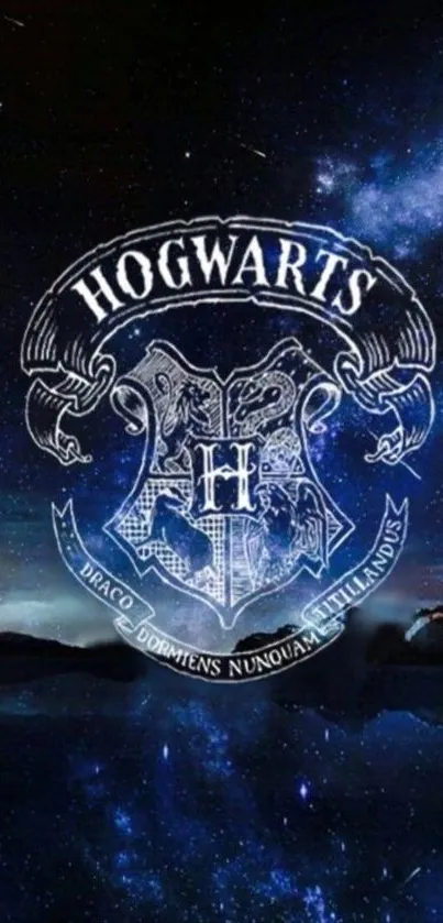 Hogwarts crest against a dark blue starry night sky wallpaper.