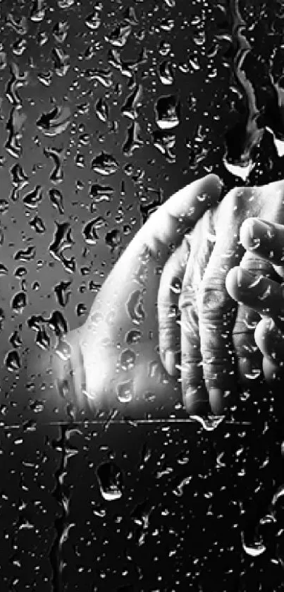 Hands held amidst falling raindrops on a dark background.