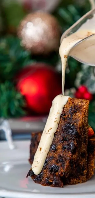 Festive fruitcake slice with creamy sauce on holiday-themed background.