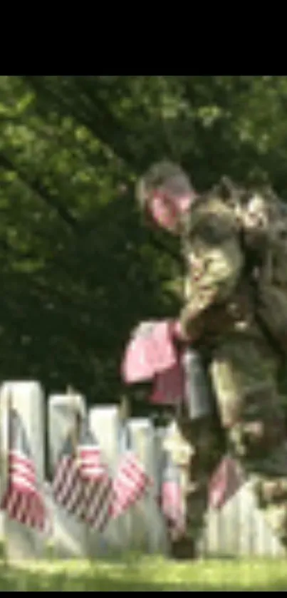 Soldier honoring fallen at cemetery, flags on graves.