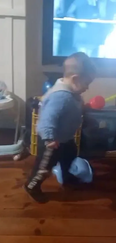 A toddler walks in a cozy room with toys and a screen in the background.