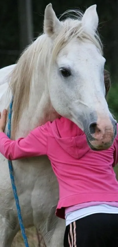 Person hugging a white horse in a peaceful setting.