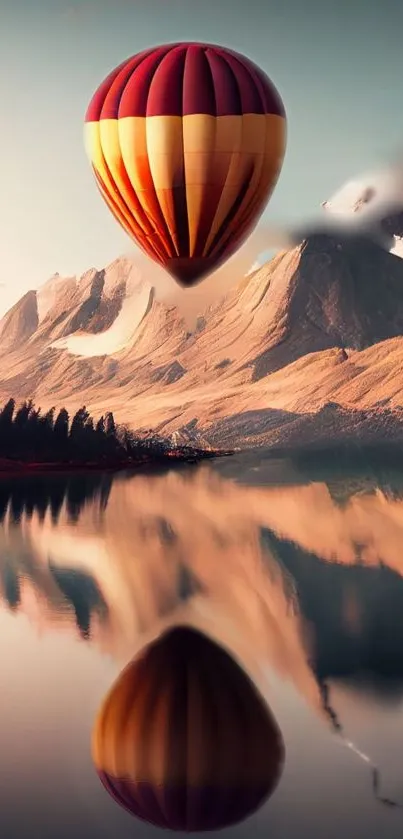 Hot air balloon over mountains and lake with reflection.